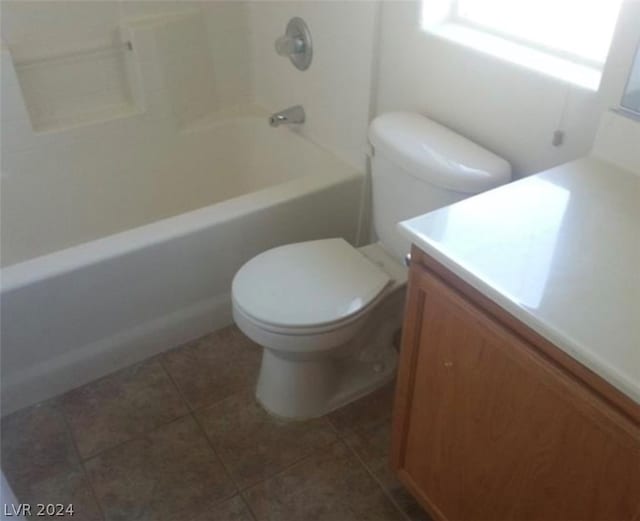 full bathroom featuring tub / shower combination, toilet, tile floors, and vanity