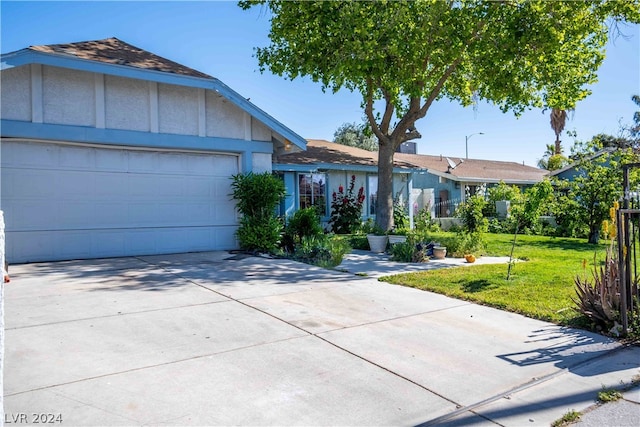 ranch-style home with a front lawn and a garage