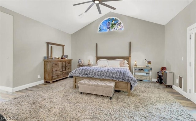 bedroom with vaulted ceiling, ceiling fan, and wood-type flooring