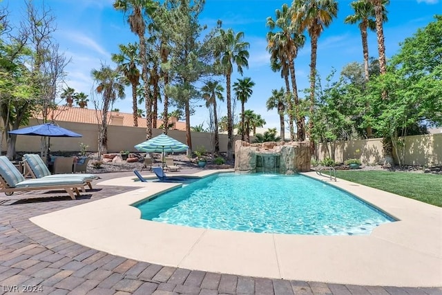 view of swimming pool with pool water feature and a patio