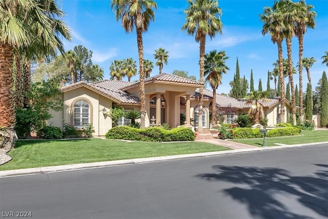 mediterranean / spanish-style house featuring a front yard