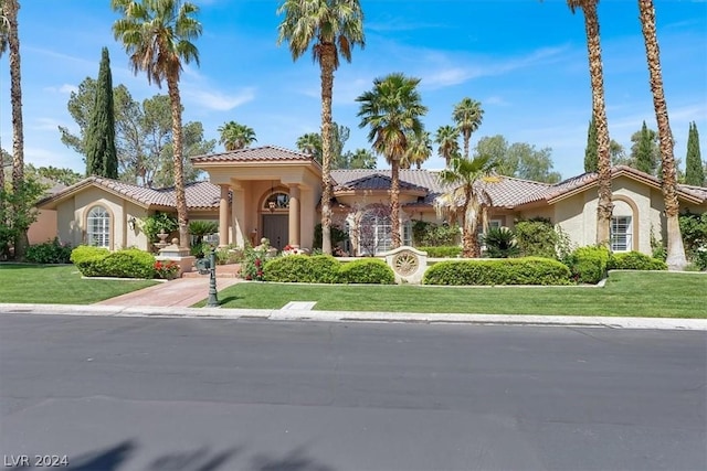 mediterranean / spanish-style house featuring a front yard