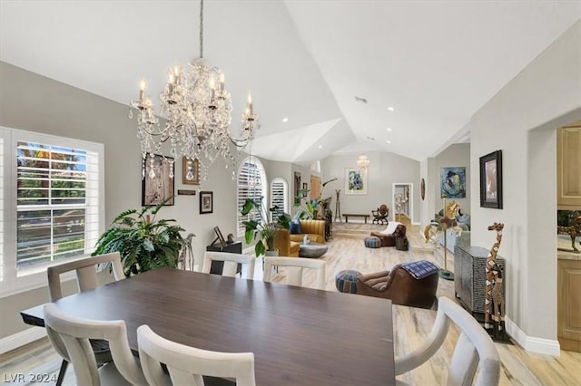 dining room featuring lofted ceiling, light hardwood / wood-style flooring, and a notable chandelier