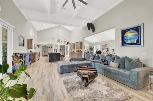 living room featuring ceiling fan, light wood-type flooring, beamed ceiling, and coffered ceiling