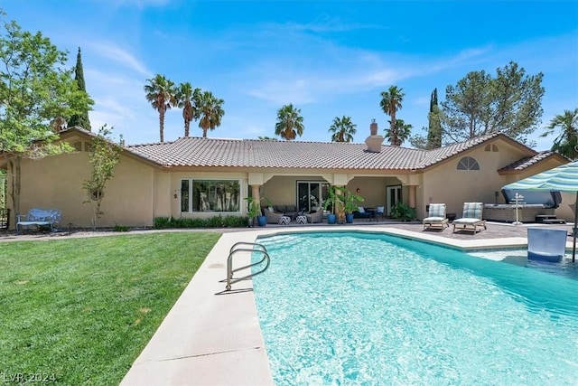 view of pool with a yard and a patio