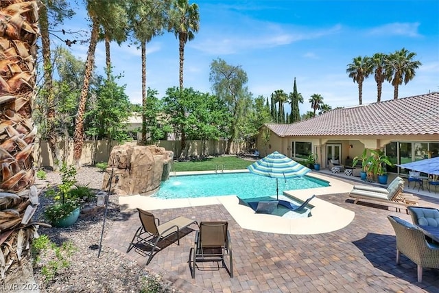 view of pool featuring pool water feature and a patio area