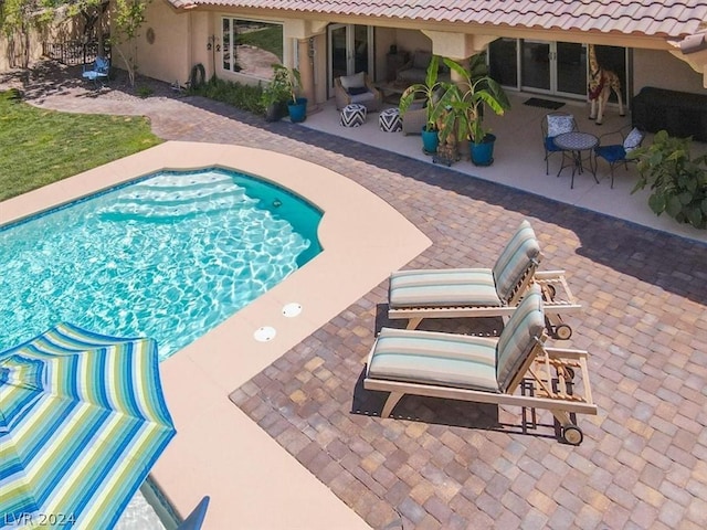 view of swimming pool with a patio