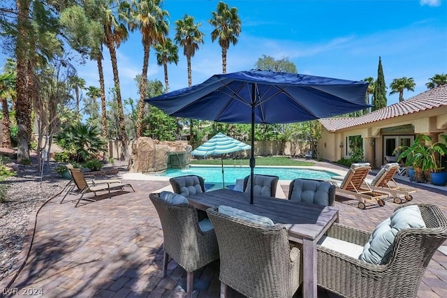 view of patio featuring pool water feature and a fenced in pool