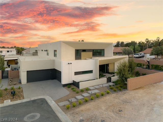 view of front facade featuring a balcony and a garage