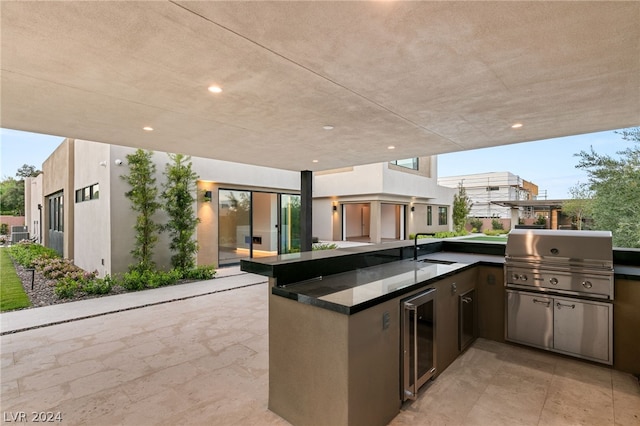 view of patio featuring sink, wine cooler, area for grilling, and a grill