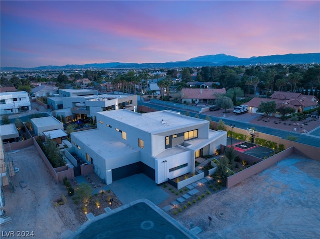 aerial view at dusk featuring a mountain view