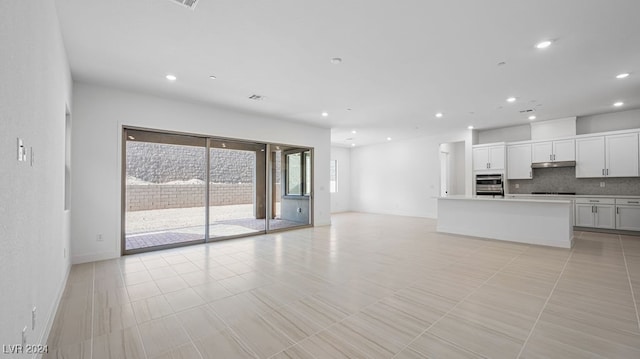 unfurnished living room featuring light tile patterned floors