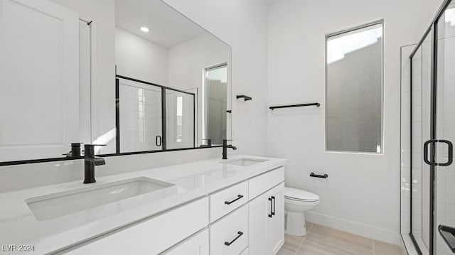 bathroom featuring vanity, a shower with shower door, and toilet