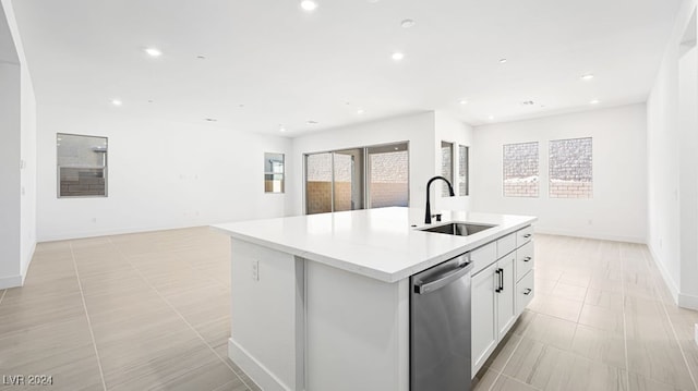 kitchen featuring a center island with sink, plenty of natural light, sink, and stainless steel dishwasher