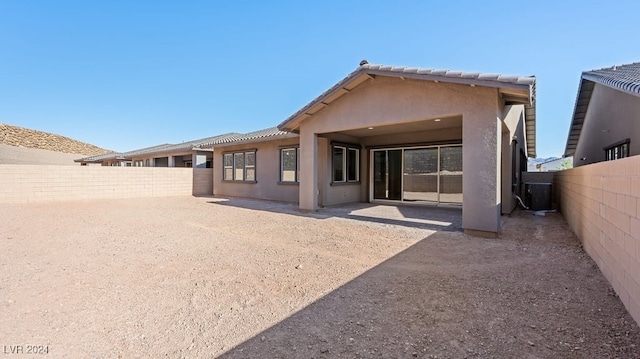 back of property featuring central air condition unit and a patio area