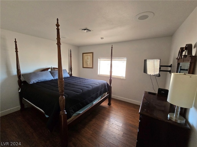 bedroom featuring dark hardwood / wood-style flooring