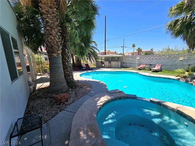 view of pool with an in ground hot tub