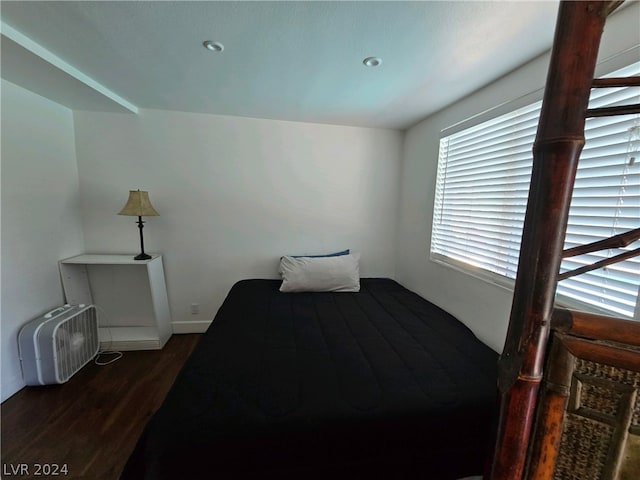 bedroom with dark hardwood / wood-style floors