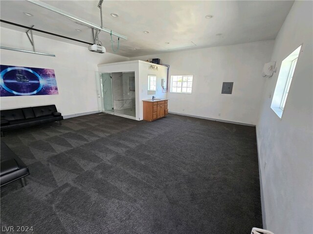 unfurnished living room with dark colored carpet