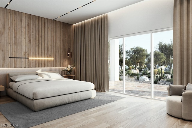 bedroom featuring access to outside, wooden walls, and light hardwood / wood-style flooring