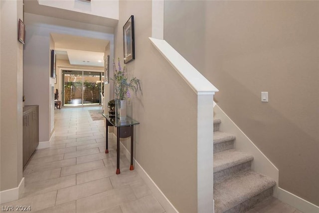 hall featuring light tile patterned floors