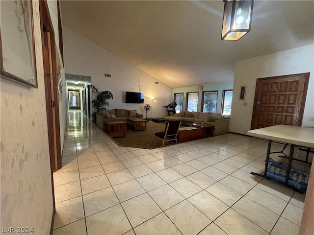 tiled living room featuring vaulted ceiling