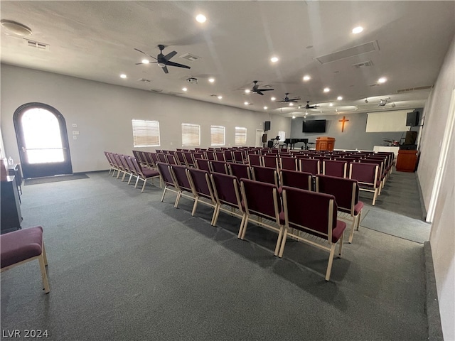 carpeted dining room with ceiling fan