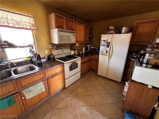 kitchen with sink, light tile flooring, and white appliances