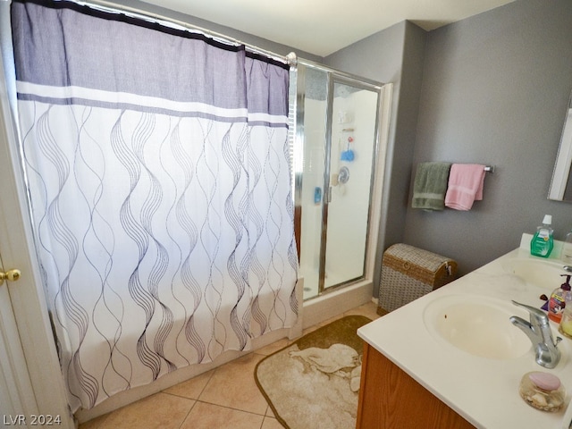 bathroom featuring tile flooring, walk in shower, and vanity