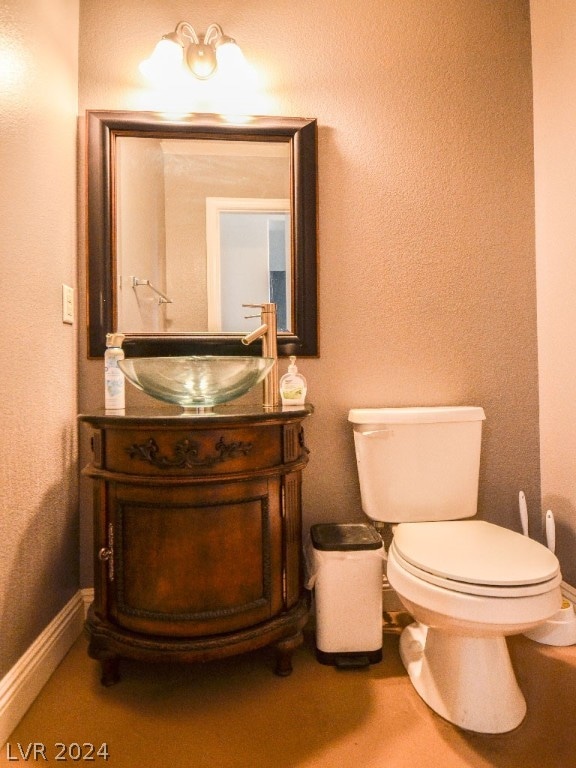 bathroom featuring toilet and vanity