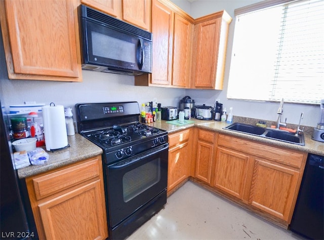 kitchen with sink and black appliances