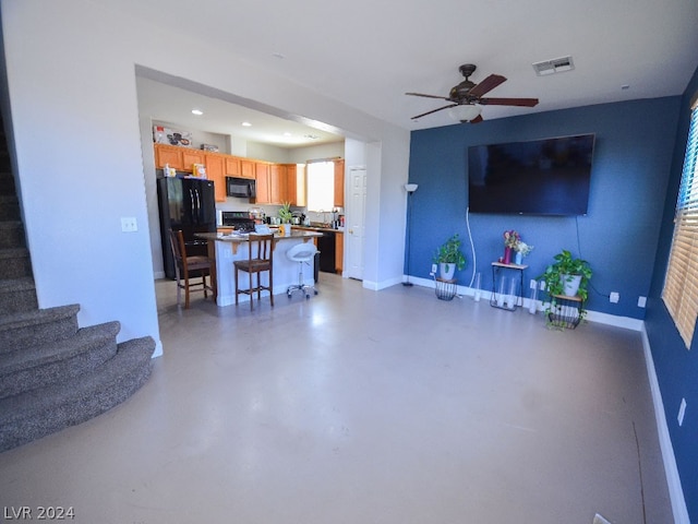 living room with concrete floors and ceiling fan