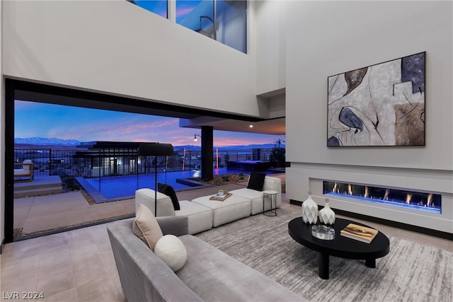 living room featuring a towering ceiling