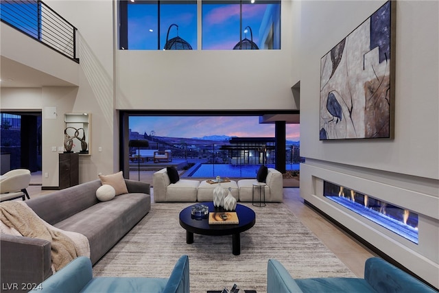 tiled living room with a towering ceiling