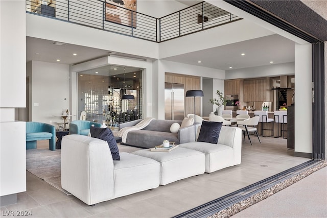 tiled living room featuring a high ceiling