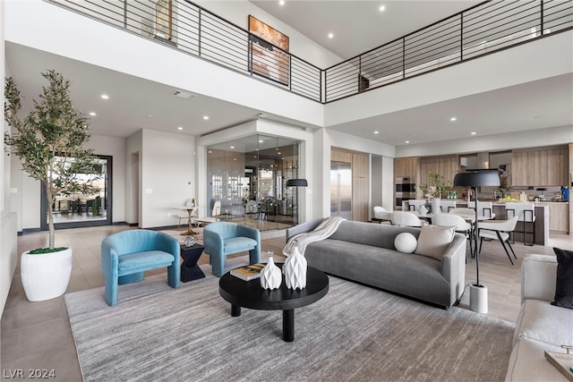 tiled living room featuring a high ceiling