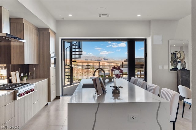 dining room featuring light tile patterned flooring, plenty of natural light, and sink