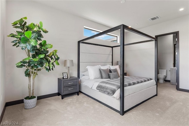 carpeted bedroom featuring connected bathroom