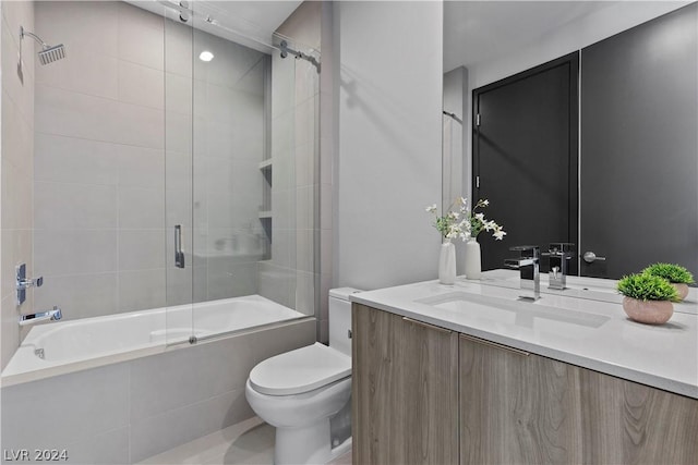 full bathroom with tile patterned floors, toilet, vanity, and combined bath / shower with glass door