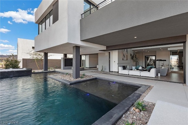 view of swimming pool with an outdoor living space and a patio