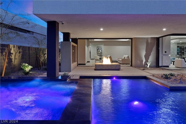 view of pool featuring a fire pit and a patio