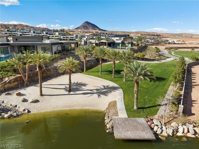 view of home's community featuring a lawn and a water and mountain view