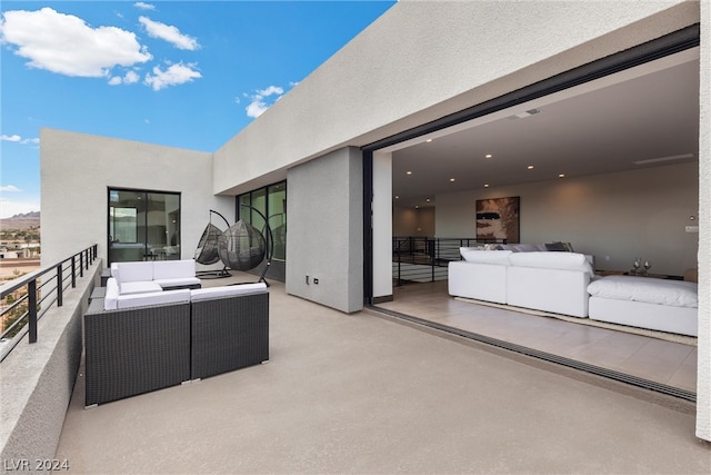 view of patio featuring outdoor lounge area and a balcony