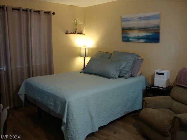 bedroom with dark wood-type flooring