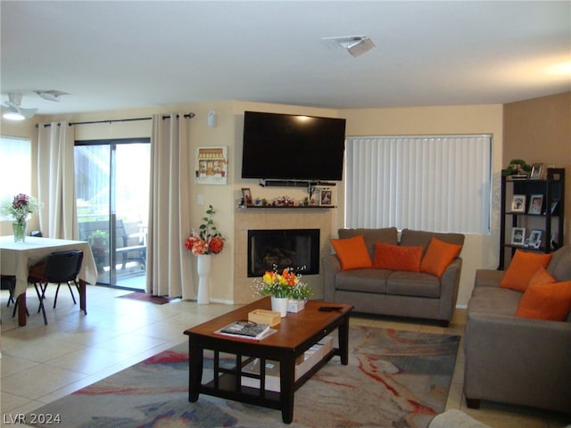 tiled living room with a tile fireplace