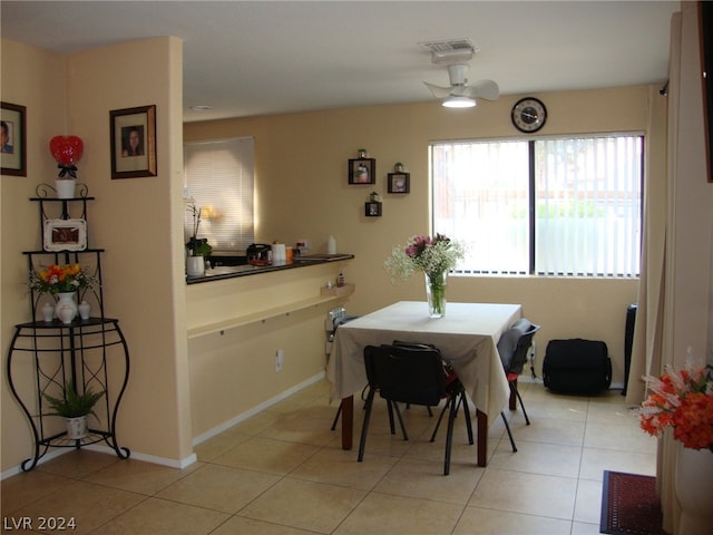 tiled dining area with ceiling fan