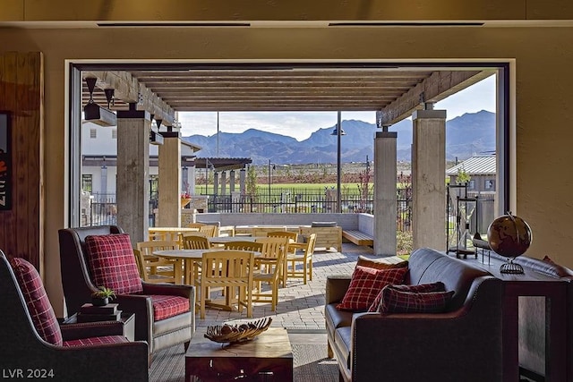 view of patio featuring a mountain view, an outdoor living space, and a pergola