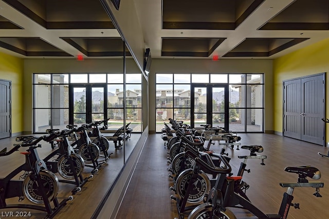 gym with french doors and coffered ceiling