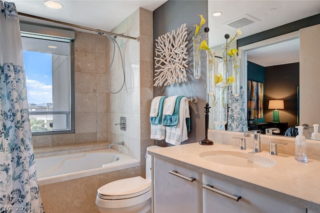 full bathroom with shower / tub combo with curtain, vanity, and toilet