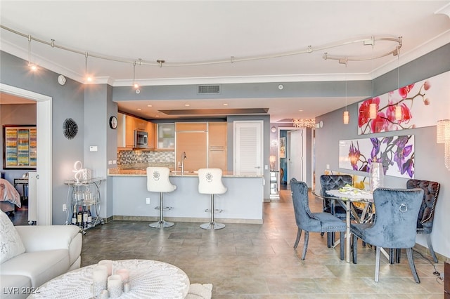 interior space with track lighting and sink